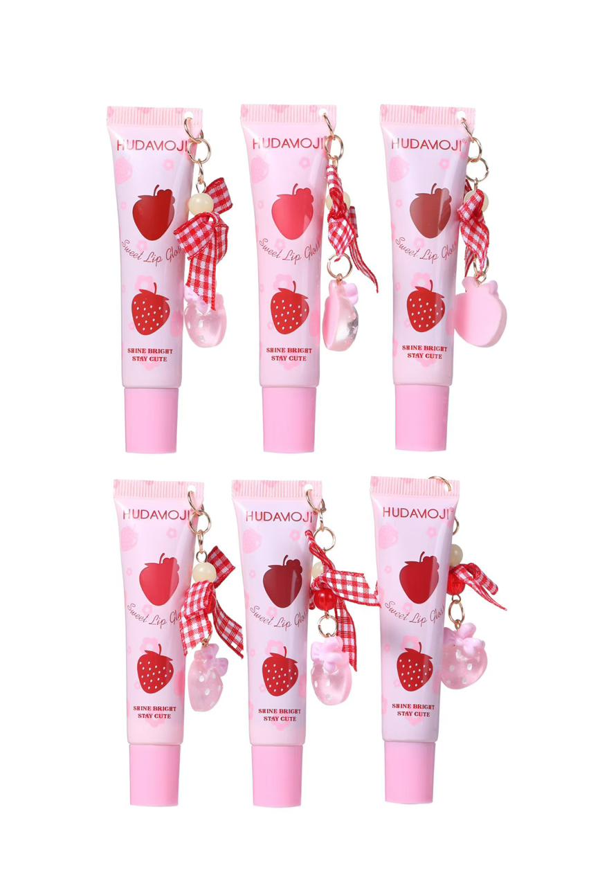 Six pink Hudamou hand cream tubes arranged in two rows on a white background, each decorated with a strawberry illustration, a red-and-white gingham ribbon, and a small charm.
