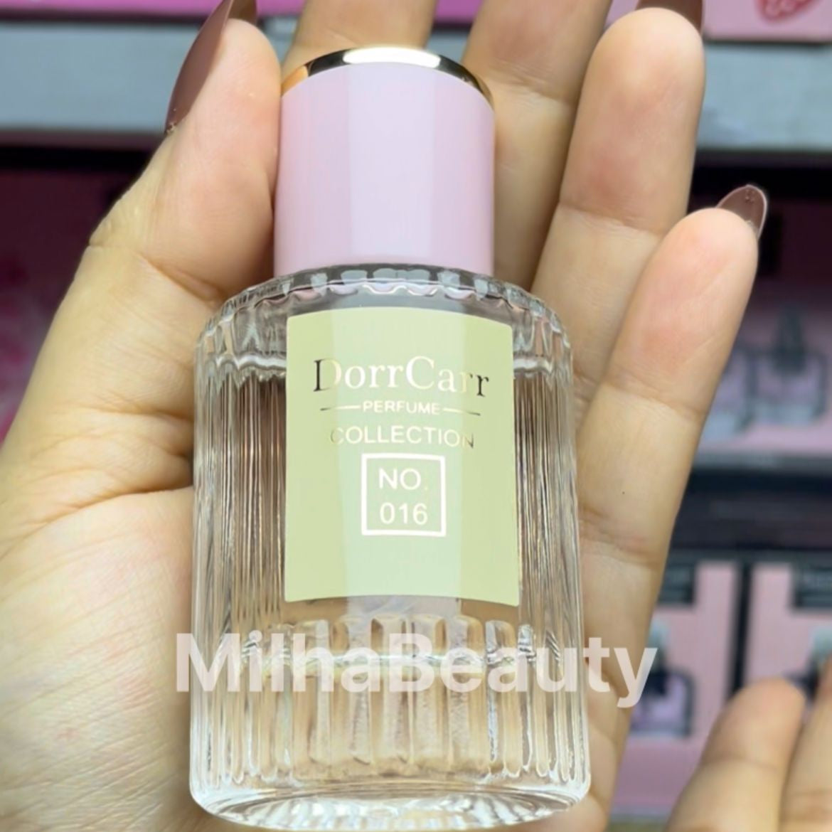 Bottle of DiorCarvée Collection No 016 held in a hand with blurred background