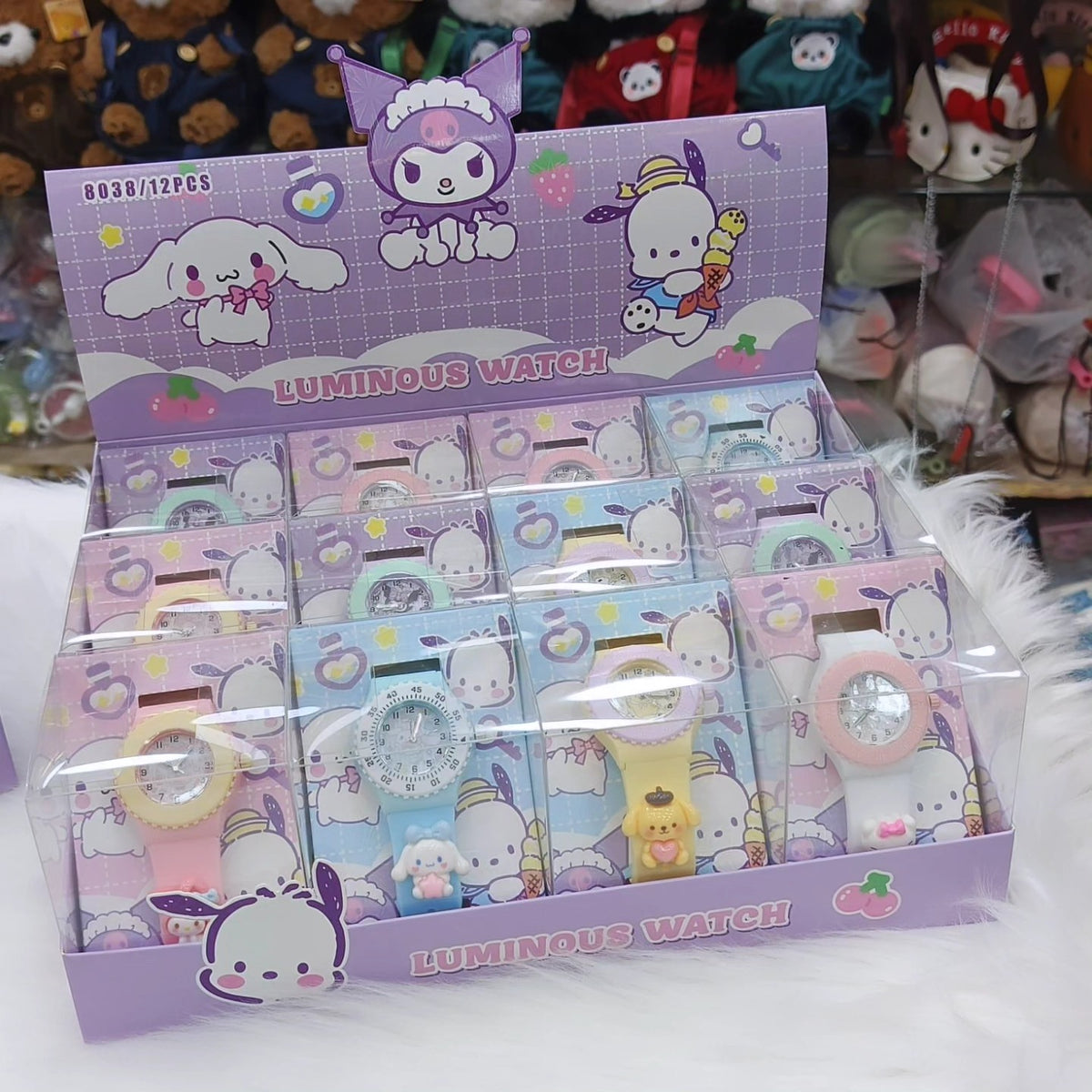 Display of colorful children's watches with cartoon characters in a clear box.