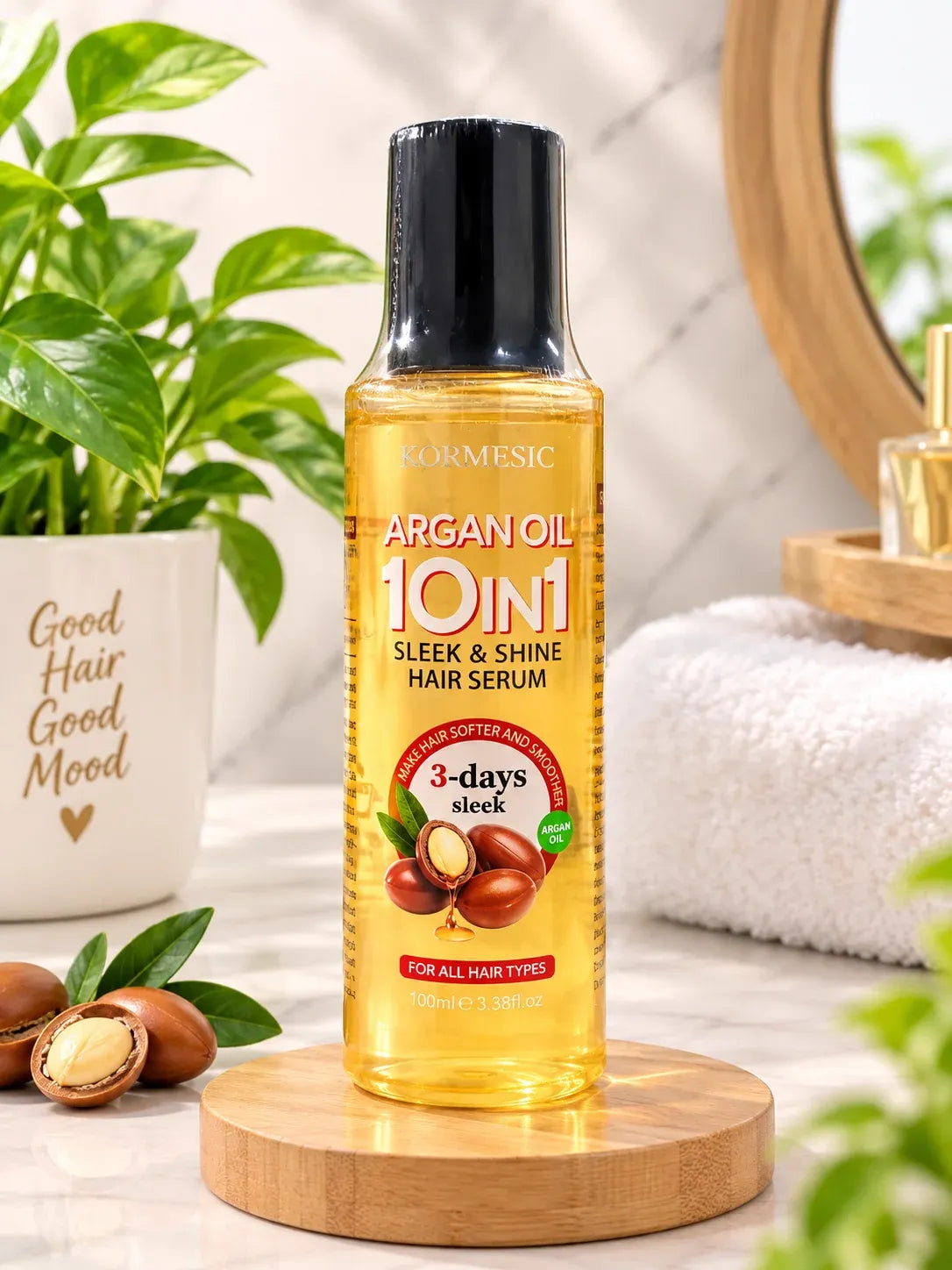 A bottle of NORMESIC Argan Oil 10in1 Sleek & Shine Hair Serum stands on a round wooden coaster. The bottle is filled with golden-yellow liquid and has a black cap.