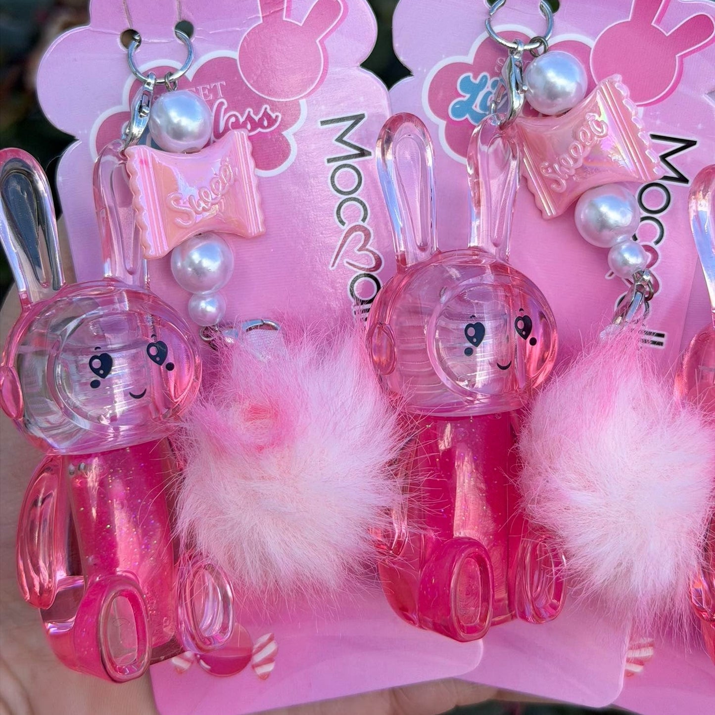 Pink bunny-shaped hair clips with white pom-poms in packaging