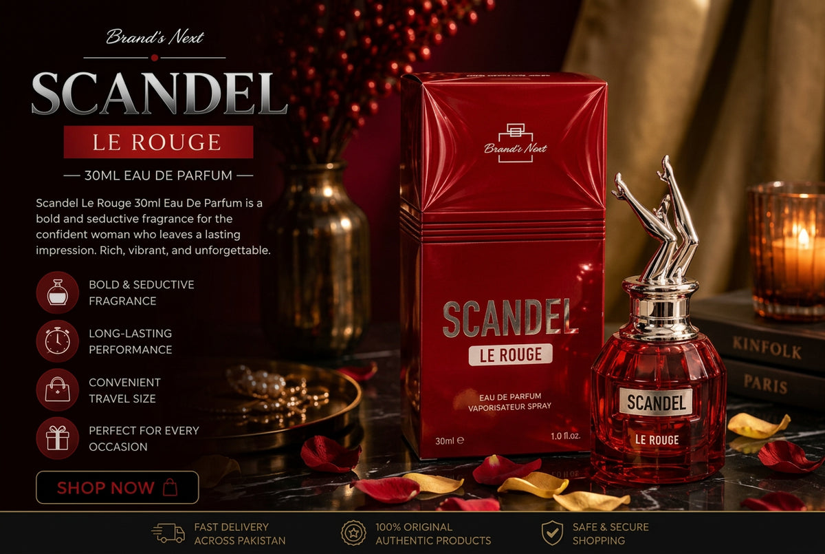 Brand's Nest Scandal Le Rouge 30ml Eau De Parfum bottle and its red packaging box, displayed on a table with candles and rose petals in a warm, atmospheric setting.