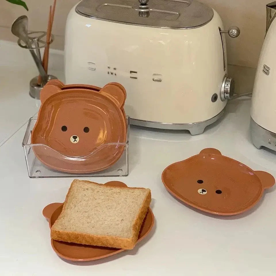 Bear-shaped toast rack with a toaster in the background