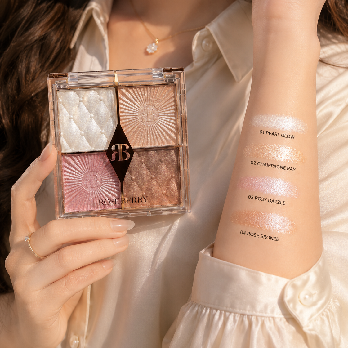 A close-up of a person holding a four-shade eyeshadow palette from Balmy, with swatches applied on their forearm. The palette contains four textured shimmer shades: quilted white, sunburst champagne, pink starburst, and rose gold
