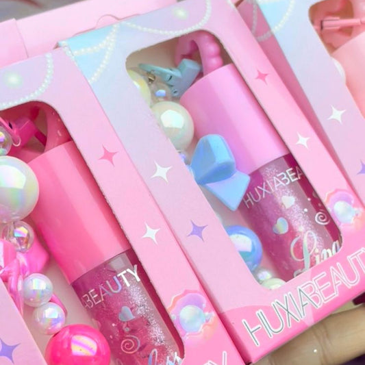 Pink cosmetic products with 'HUUXA BEAUTY' branding in a box.