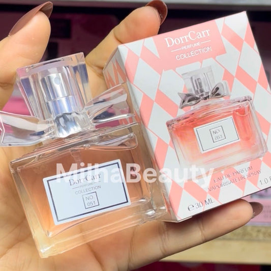Perfume bottle and packaging held by a hand, with 'DoorCara' branding visible.