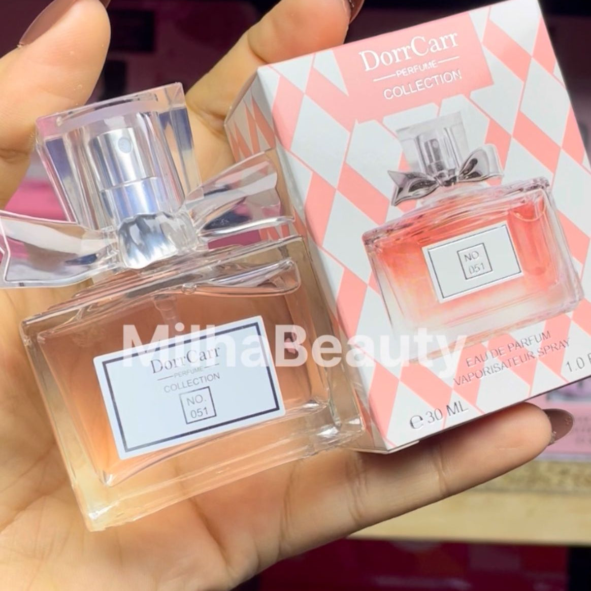 Perfume bottle and packaging held by a hand, with 'DorrCara' branding visible.