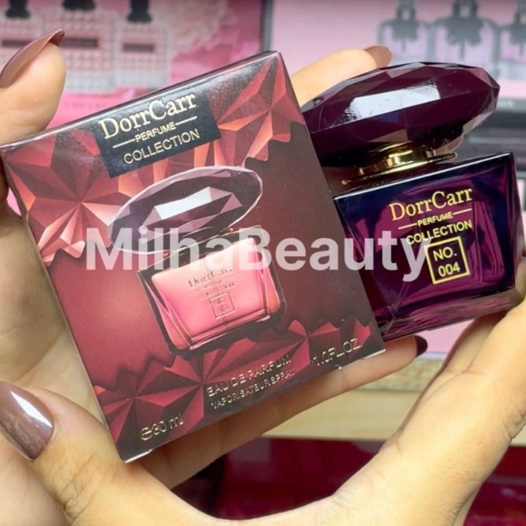 Dor Carr perfume bottle and packaging held by a person with 'Milha Beauty' branding.