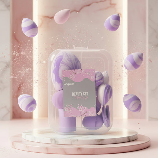 Angoox beauty set in a clear plastic case with a pink floral label, displayed on a marble pedestal with floating purple and white sponge shapes against a soft pink marble background.