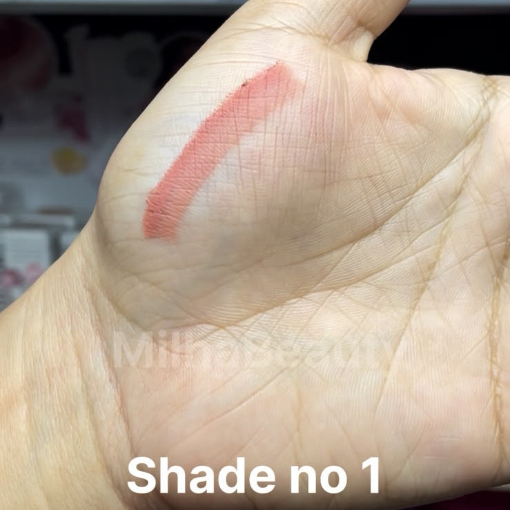 A close-up of a hand showing a swatch of a pinkish-red makeup shade labeled 'Shade no 1'. The image includes a phone app interface with text overlays showing 'Price 150/- each' and a website URL.