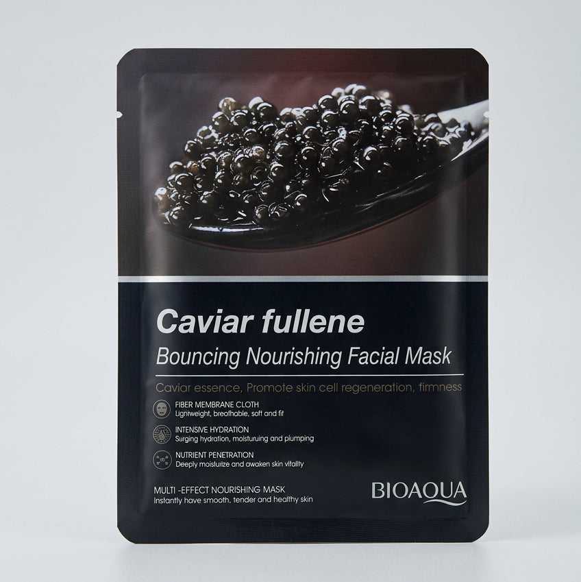A single facial mask packet labeled 'Caviar fullene Bouncing Nourishing Facial Mask' by Bio-Ola, placed on a beige patterned fabric surface.