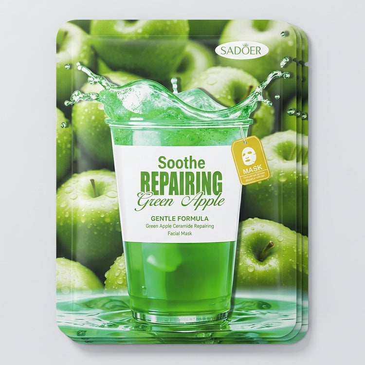 Sadler Soothe Repairing Green Apple facial mask sheet packaging, featuring a green apple and juice splash design, placed on a beige textured fabric surface.