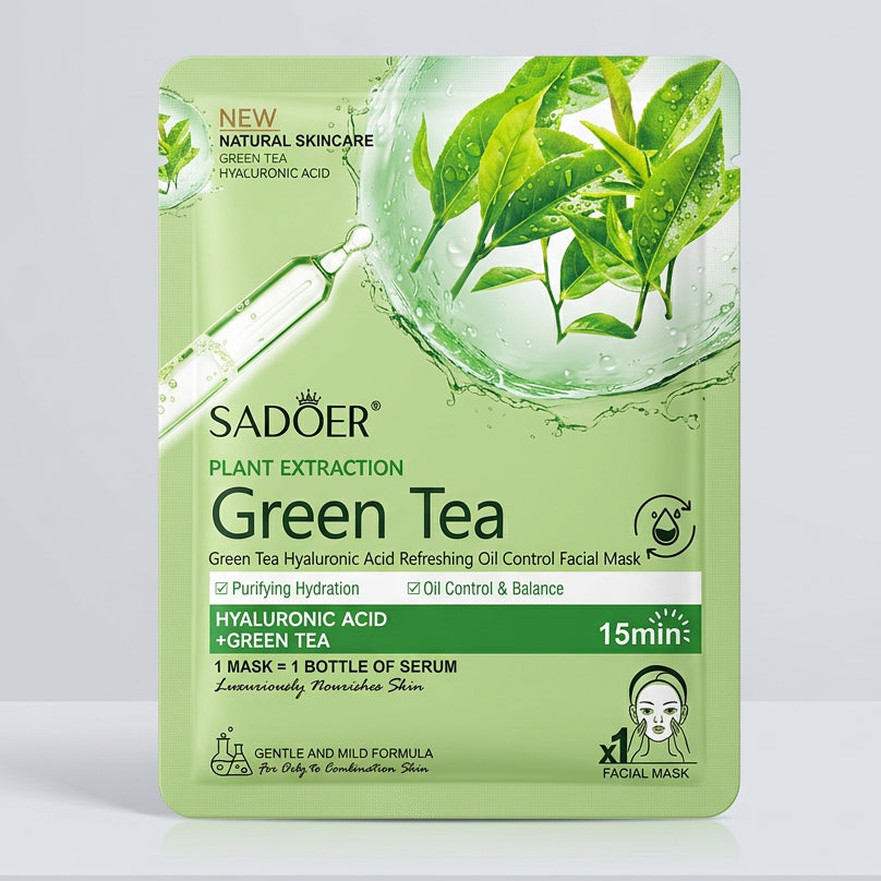 A package of Sadoer Green Tea Plant Extraction facial mask resting on a beige patterned fabric surface. The packaging is light green with illustrations of green tea leaves and a dropper, and text indicating it contains hyaluronic acid and green tea.
