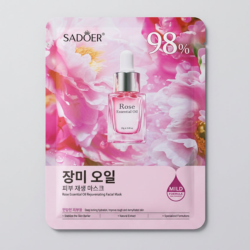 A pink and purple Sadler Rose Essential Tea facial mask packet lying on a textured beige fabric surface. The packaging features a rose illustration, a small bottle graphic, and Korean text including 'Sadler' and 'Rose Essential Tea'.