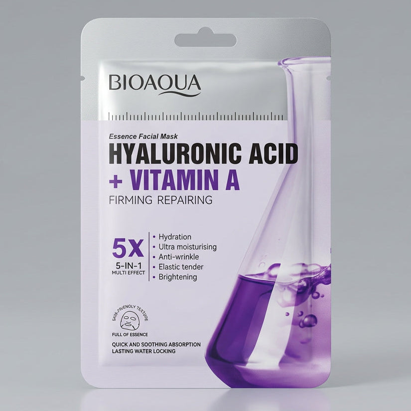 A hand holds a package of BIOAOUA Hyaluronic Acid + Vitamin A facial mask powder. The packaging is primarily white with purple text and a purple liquid splash graphic, with other colorful product packets partially visible behind it on a dark surface.