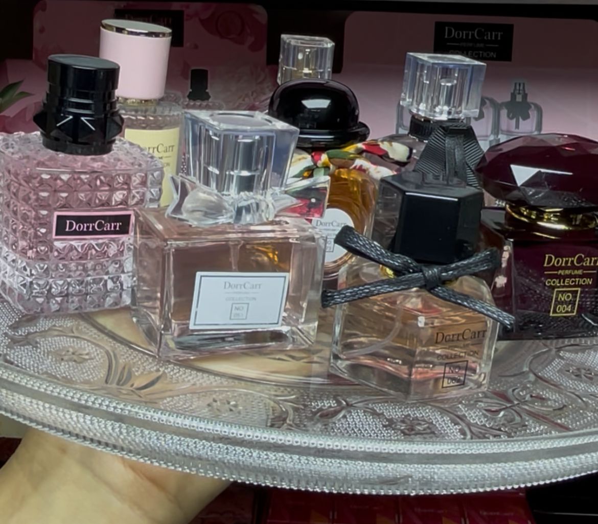 Collection of DorrCare perfume bottles on a decorative table