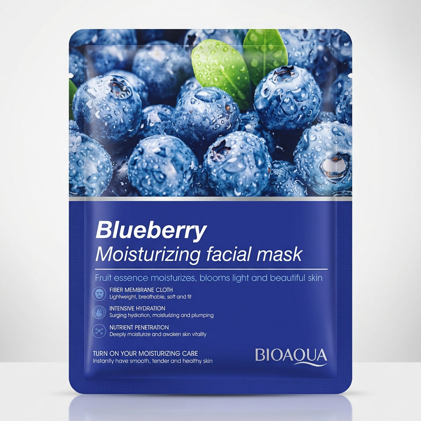 A packet of BIOAQUA Blueberry Moisturizing facial mask placed on top of a black laptop keyboard, with a partial bottle of skincare visible below.