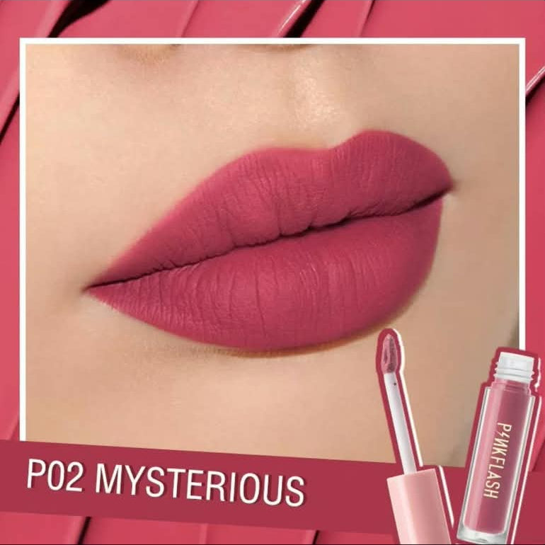 A close-up of lips wearing a matte dusty rose pink lipstick, with a small applicator and lipstick tube shown at the lower right. Text reads 'P02 MYSTERIOUS' on a pink banner.