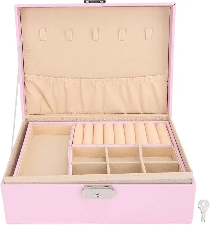 Pink jewelry organizer box with a lock and key, shown open to reveal beige velvet interior compartments, ring rolls, and a top hanging slot system.
