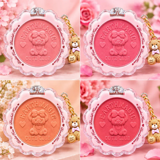 Four round blush compact-style makeup pans arranged in a 2x2 grid, each with a scalloped clear plastic frame, embossed teddy bear face in the center, and a small teddy bear charm on a gold chain. The shades shown are pink, coral, peach, and rosy orange, all on a soft pink floral background.