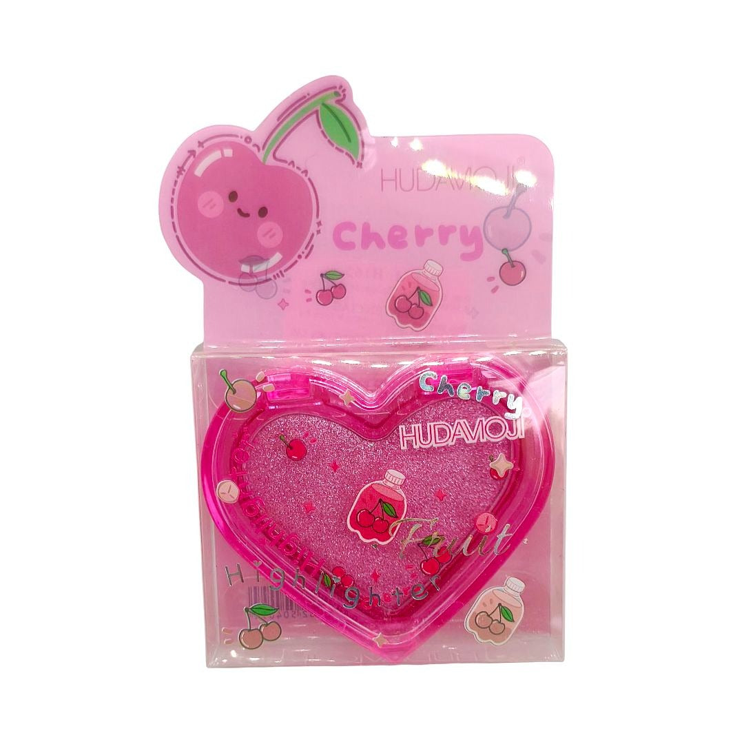 A pink heart-shaped glittery cosmetic compact in its original retail packaging, featuring cherry illustrations and the brand name HUDAMOJI.