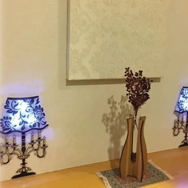 Decorative wall stickers of lamps and a vase on a plain wall.