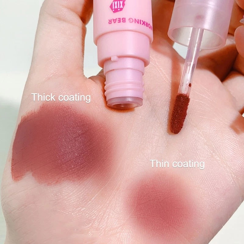 A hand holding a pink lip gloss tube and applicator, showing two swatches of the gloss on the palm labeled 'Thick coating' and 'Thin coating'.