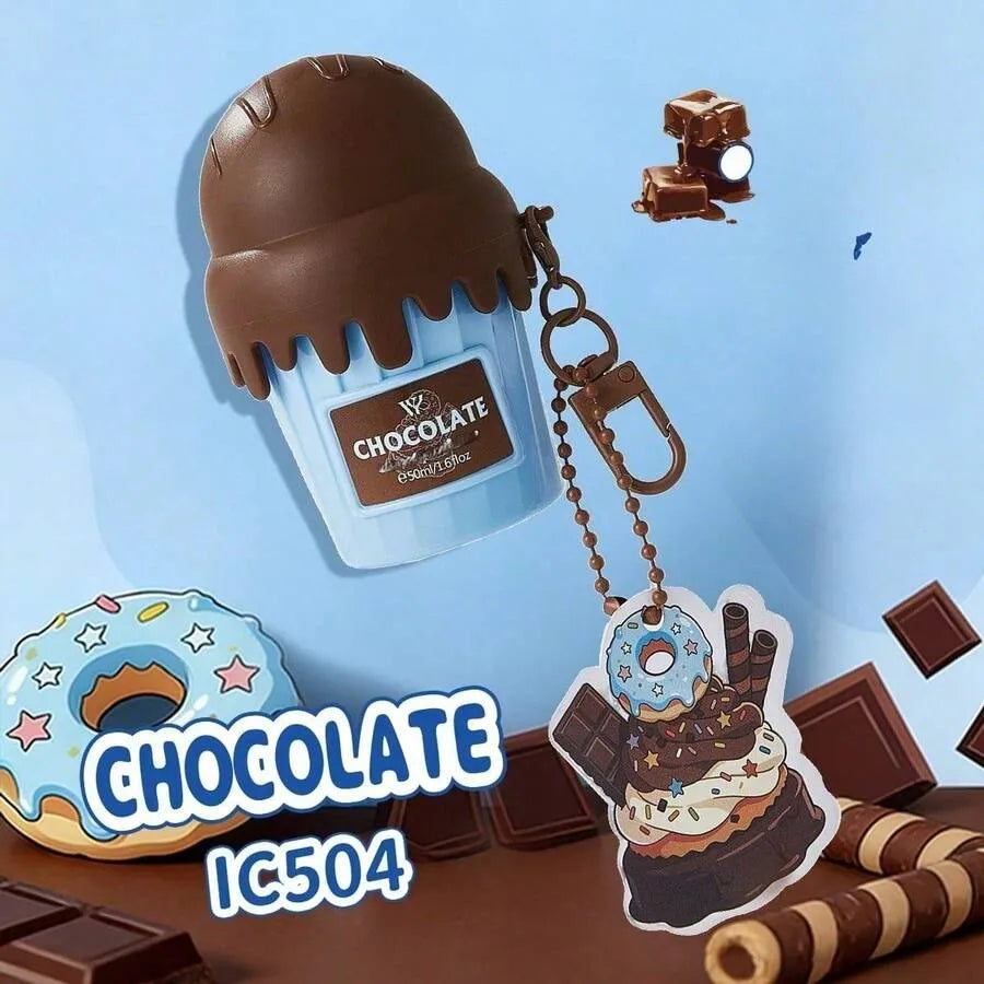 Chocolate-themed keychain accessory set featuring a cupcake-shaped container with a chocolate scoop lid, a donut-shaped charm, and a small chocolate block keychain, shown on a light blue background with decorative chocolate and donut props.