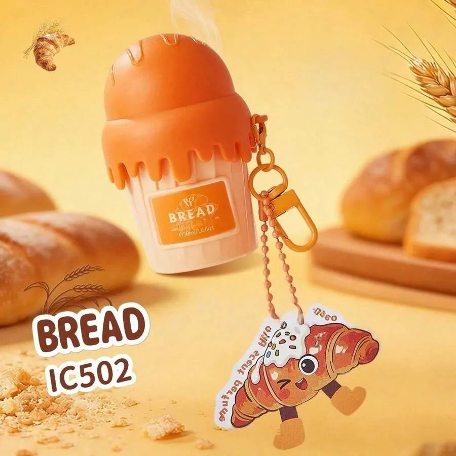 A novelty bread-shaped keychain or bottle cap accessory shown on a warm yellow bakery-themed background. The main item is shaped like a cupcake with an orange frosting top and a label reading BREAD.