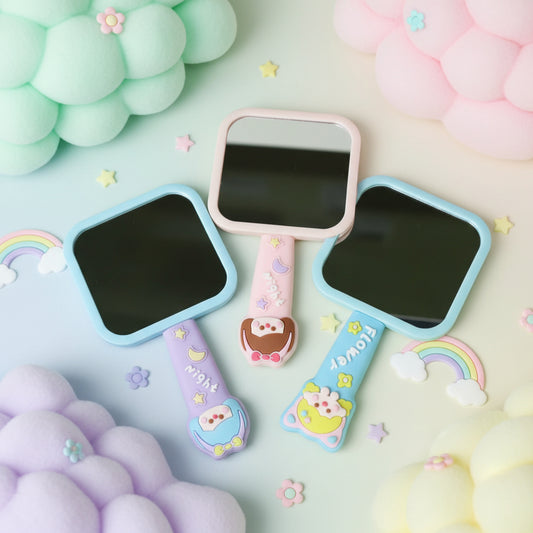 Colorful children's mirror with cartoon character handles on a white background