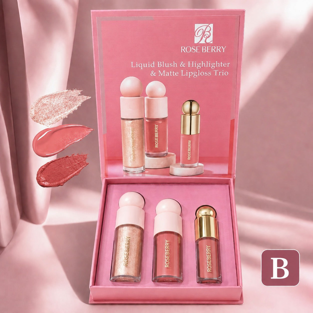 Rose Berry Liquid Blush & Highlighter & Matte Lipgloss Trio in a pink presentation box, with three cosmetic tubes displayed inside and three swatches of shimmering and matte pink lip color shown on the left against a soft pink draped background.