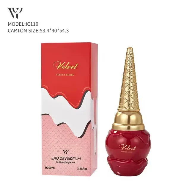 A red perfume bottle with a gold cone-shaped cap stands next to its matching red, white, and pink box on a plain white background. The box and bottle both show the brand name Velvet.