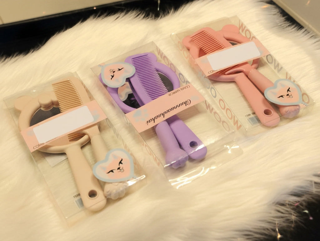 Set of hairbrushes and combs in clear packaging on a textured surface