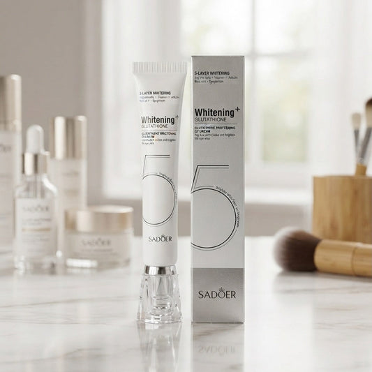 Sadoer 55 Whitening + Laser Whitening tube and box displayed on a marble countertop with cosmetic bottles and brushes in a softly lit room.