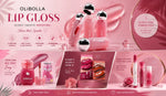 Olibolla Lip Gloss collection in shades of pink, featuring multiple bottles with silver caps, lip gloss tubes, and decorative pink elements on a pink background.