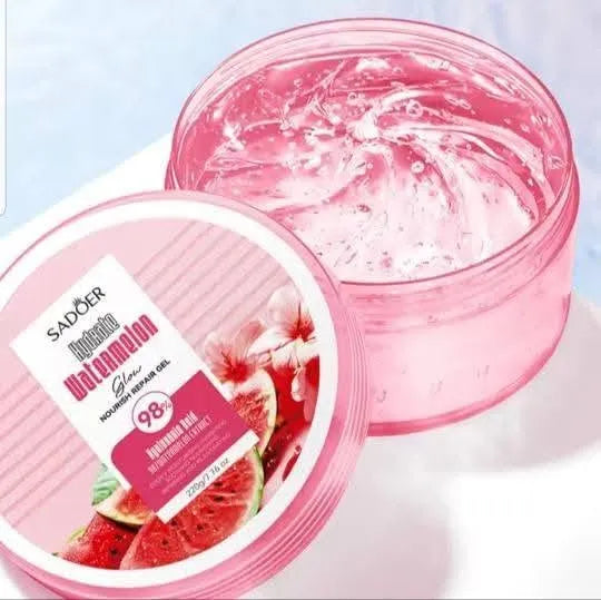 Pink Sadoer Watermelon Peel-off Mask Gel in a round plastic tub, with the lid placed in front showing a watermelon and flower label, and the gel visible inside the open container.