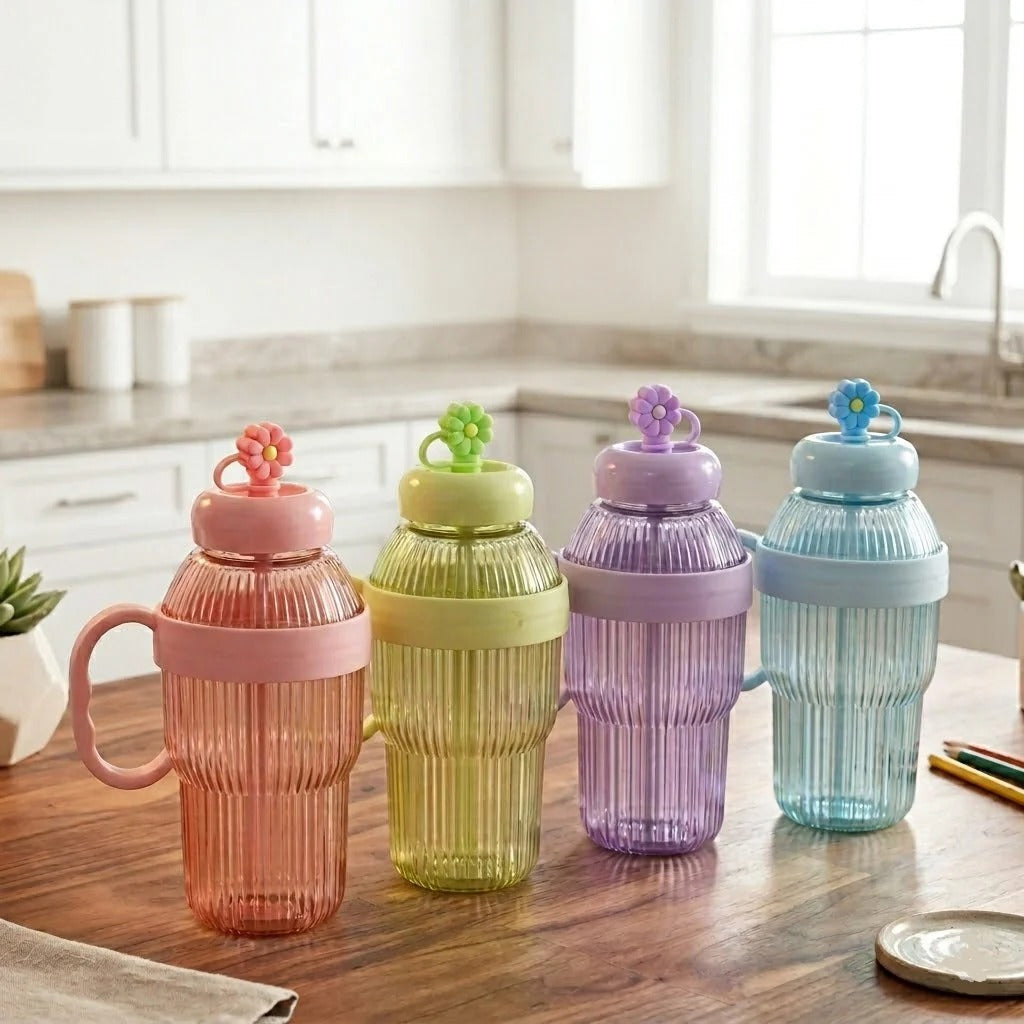 Four colorful plastic cups with decorative lids on a kitchen counter.
