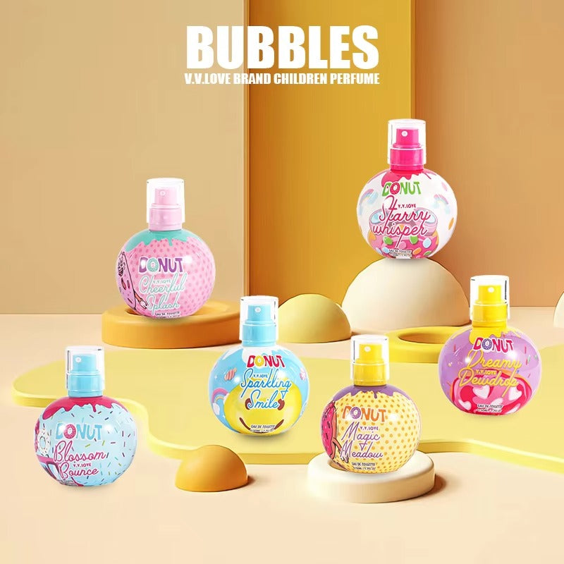 Children's perfume bottles with colorful designs on a yellow background