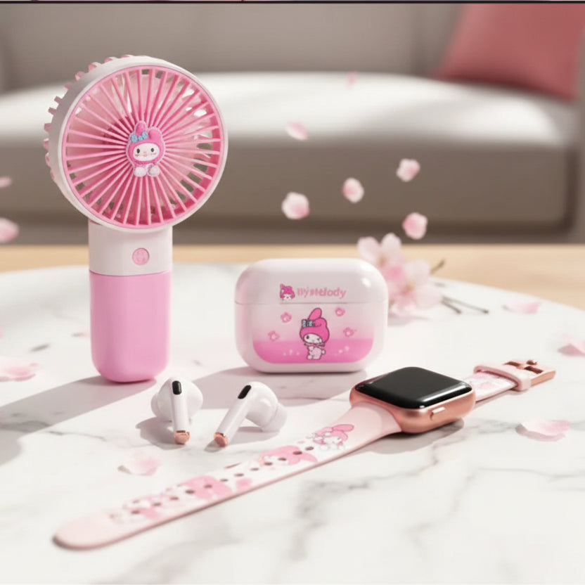 A pink My Melody themed gift set in its original packaging, featuring a handheld fan, wireless earbuds, a smartwatch, and a phone case, displayed on a wooden table with a blurred indoor background.