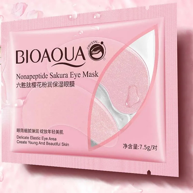 BIOAQUA Nonapeptide Sakura Eye Mask single-use packet in pink packaging, showing the product insert with two translucent pink eye patches and water droplets.