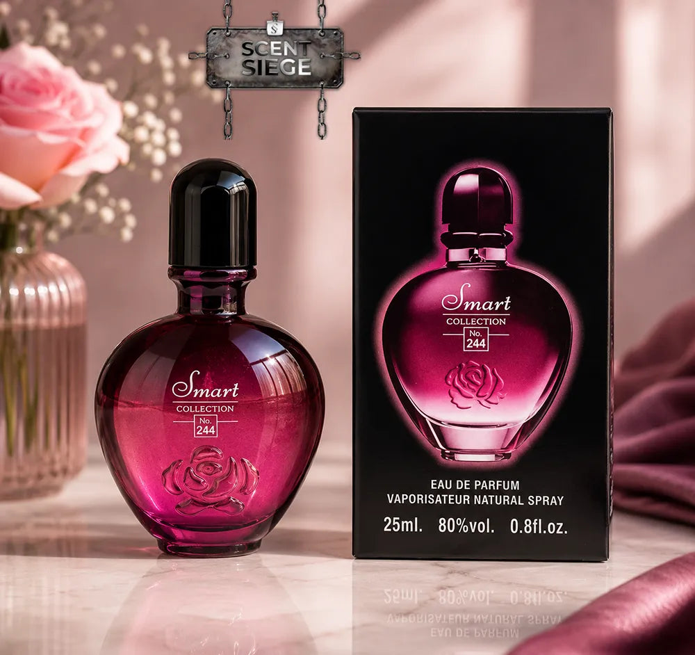 A bottle of Smart Collection 244 Eau de Parfum next to its black retail box, both featuring a magenta-pink heart-shaped bottle design with a rose engraving. The scene is styled with a pink rose in a vase and draped pink fabric on a marble surface.