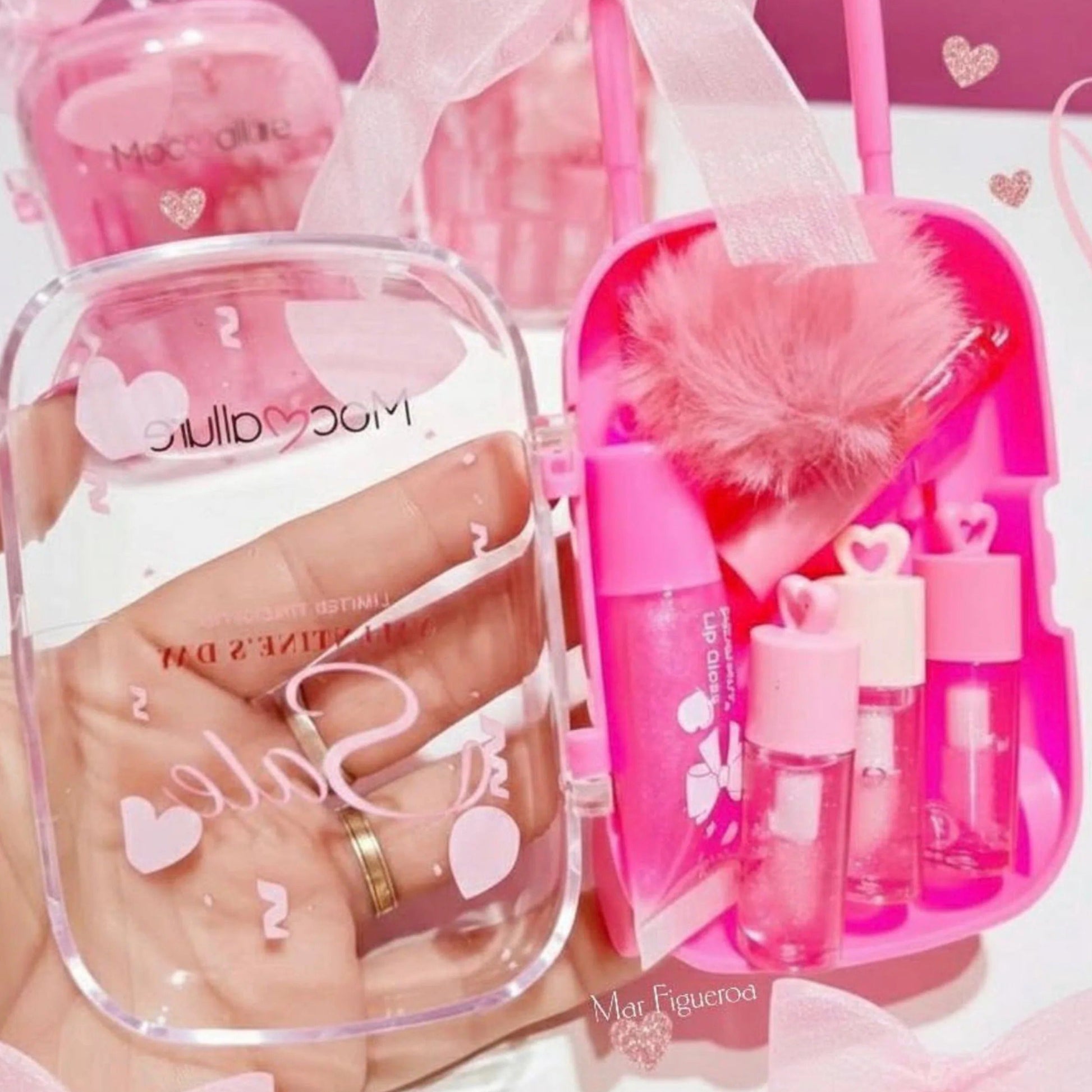 Pink cosmetic set with mirror and small bottles on a pink background