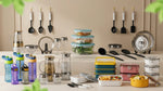 Collection of kitchen items including containers, utensils, and cookware on a table.
