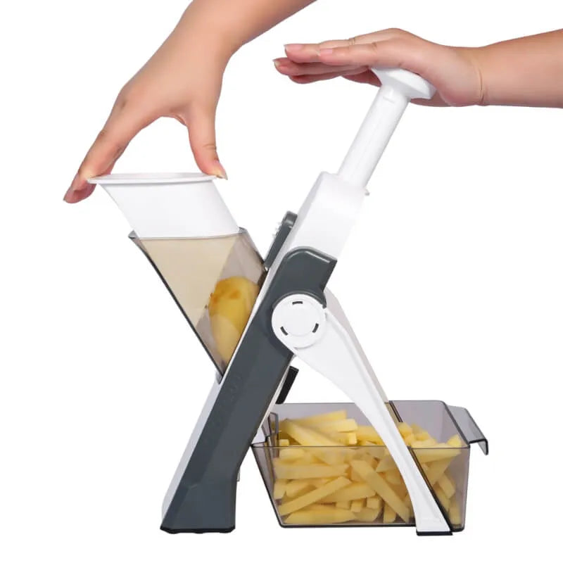 Handheld vegetable chopper with sliced vegetables on a white background