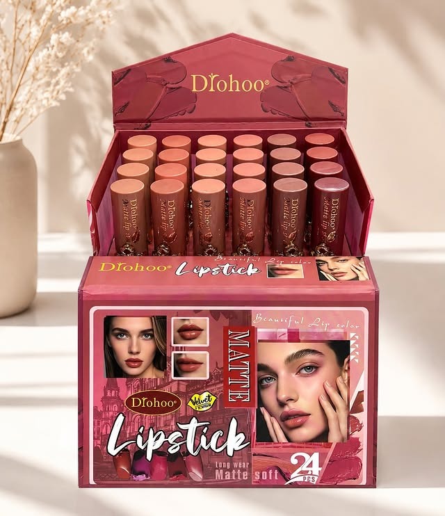 An open display box of Dfohoo matte lipstick showing multiple lipsticks in various pink and nude shades, with the product box in front on a light beige surface.