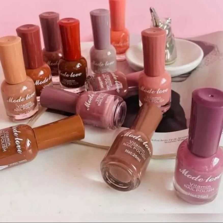 Collection of 'Made Love' nail polishes on a white surface with a pink background 