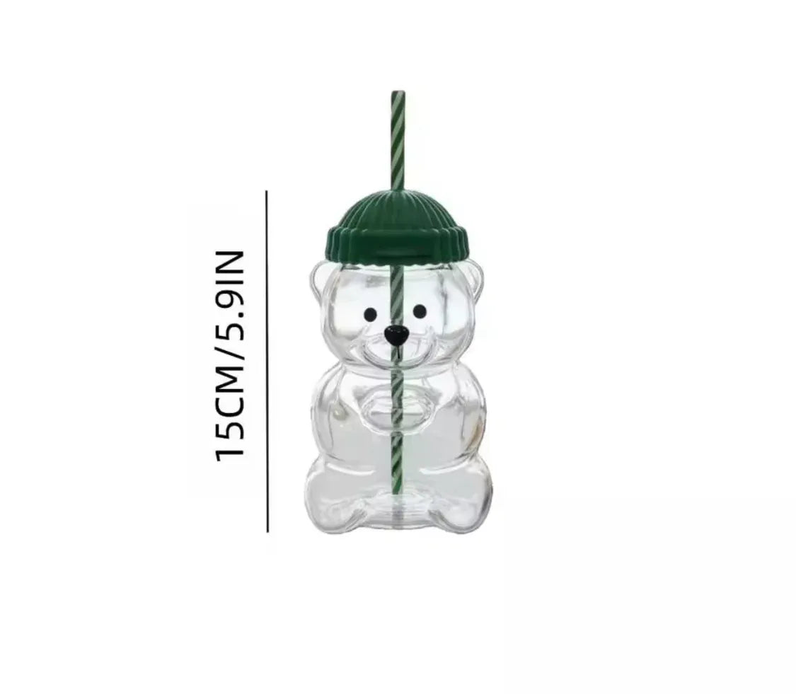 A clear bear-shaped glass tumbler with a dark green lid and a green-and-white striped straw, shown on a white background with vertical text indicating a height of 15CM/5.9IN.