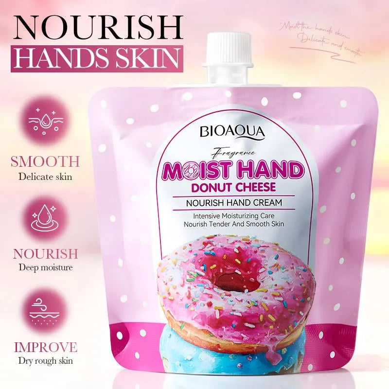 BIOAQUA Moist Hand Donut Cheese Nourish Hand Cream in a pink stand-up pouch with a white cap, shown on a soft pink gradient background with product feature icons on the left.