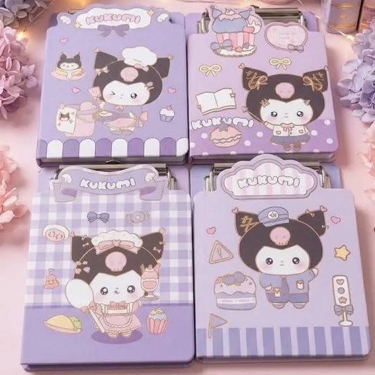 Four Kuromi-themed notebook covers arranged on a pink desk, decorated with pastel flowers, a cup of pens, and rolls of washi tape in a cute stationery setup.