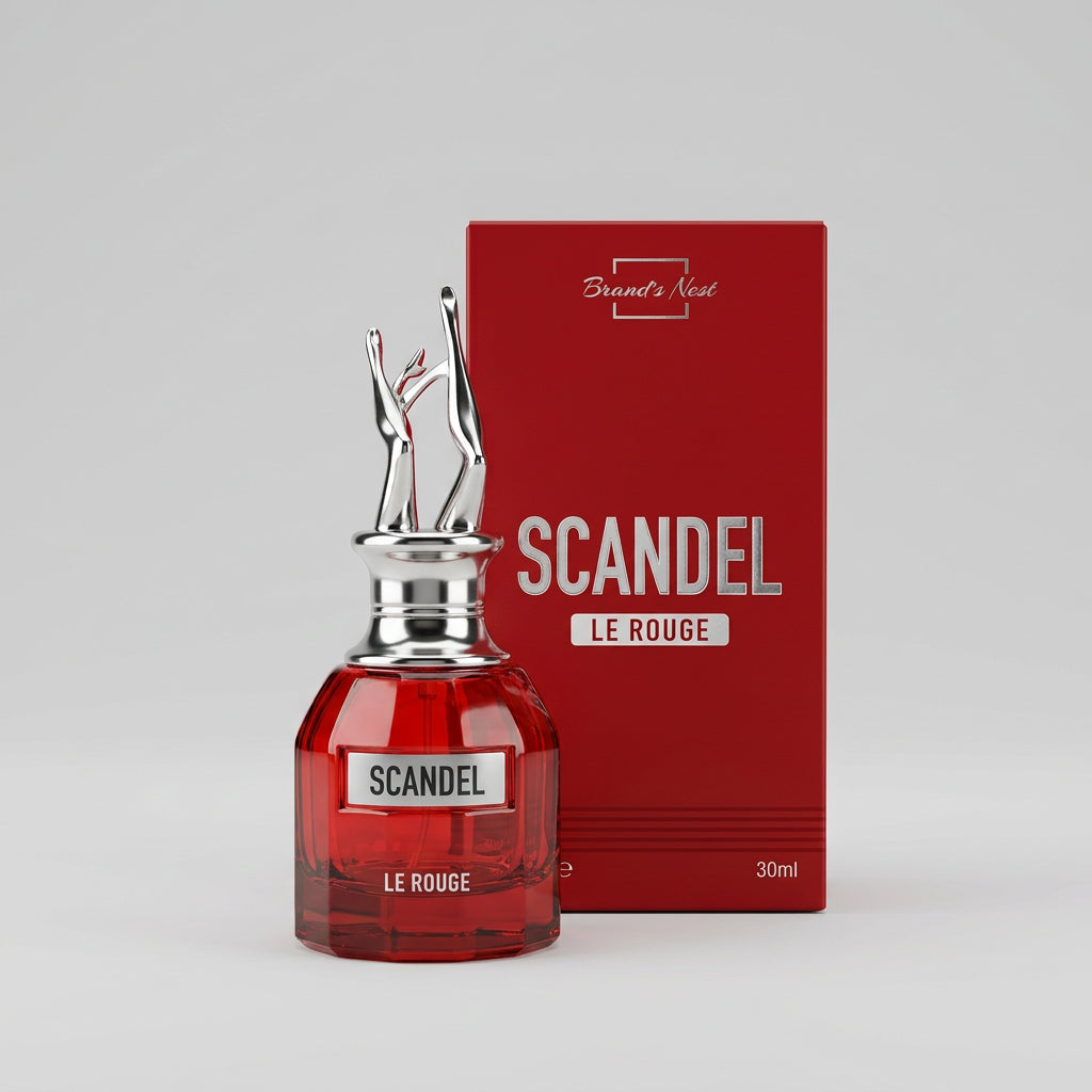 A bottle of Scandal Le Rouge perfume with a red glass body and silver deer antler cap, standing in front of its red packaging box.